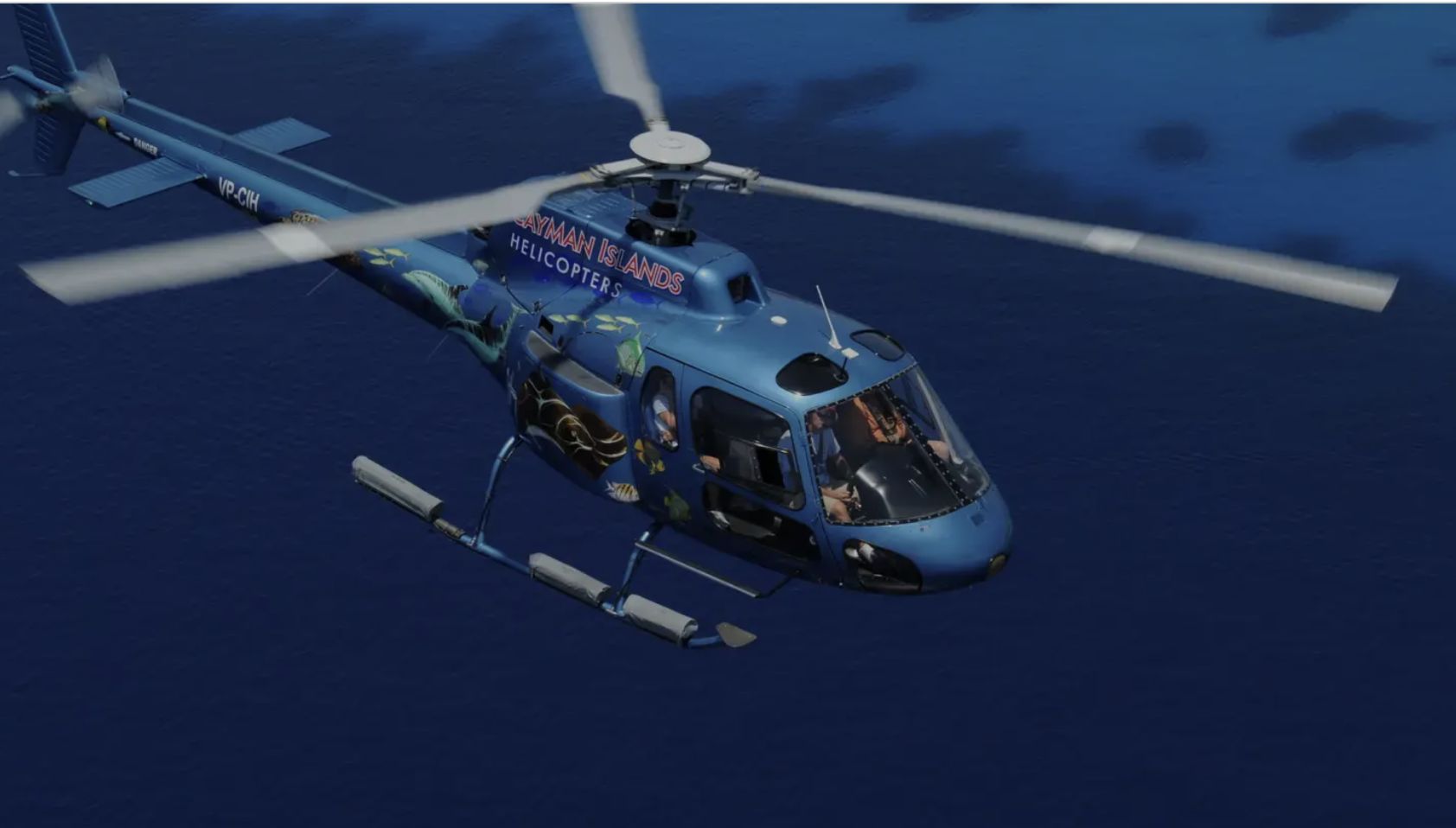The helicopter over deep blue water off Grand Cayman